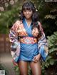 A woman in a kimono posing for a picture.