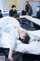 A woman laying on top of a bed in an office.